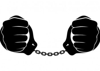 No people are visible in this image. It features a graphic illustration of two clenched fists, one on the left and one on the right, connected by a chain in the middle. The fists are black with white outlines, set against a plain white background.