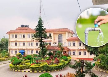 A large, beige building with red-tiled roofs and lush greenery, featuring a circular garden in the foreground. A hand turns a blue-handled faucet, releasing water into the air in the inset image.