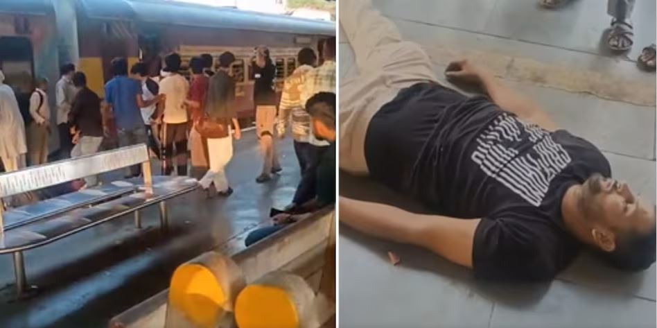 A chaotic scene at Shahdara Railway Station in Delhi, India. A crowd of people are standing near a train, while a man lies on the ground, appearing to be injured or unconscious. The man on the ground is wearing a black t-shirt with white text. In the background, a group of people are gathered, some of whom appear to be arguing or physically confronting each other. The setting is a railway station platform with a train visible in the background.