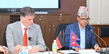 German Ambassador H.E. Udo Volz and Nepal's Ministry of Finance Secretary Mr. Ghanshyam Upadhyaya, PhD, sitting at a conference table with microphones, nameplates, and flags of Germany and Nepal, engaged in a meeting at the Ministry of Finance in Kathmandu, Nepal, on June 16-17, 2026.